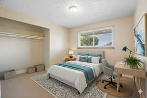 Digitally staged. Bedroom featuring carpet, a textured ceiling, and a desk