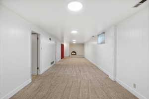 Corridor with light carpet and wooden walls