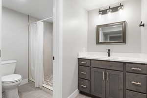 Bathroom with vanity, a stall shower, and light tile patterned flooring