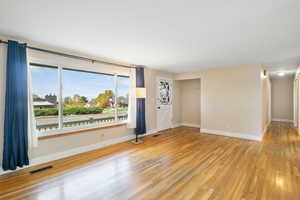 Spare room featuring light wood-style floors and baseboards