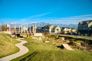 Surrounding community with a mountain view, a residential view, and a yard