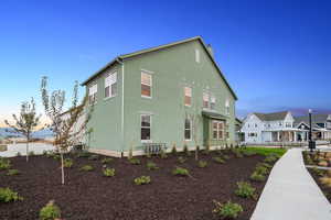View of property exterior featuring stucco siding and a residential view