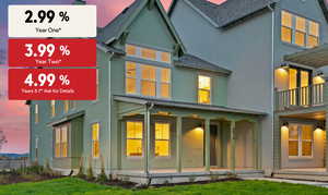 Back of property at dusk with stucco siding, roof with shingles, a porch, and a yard
