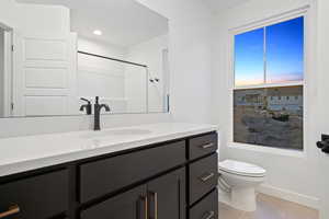 Bathroom featuring light tile patterned floors, vanity, a textured ceiling, and recessed lighting