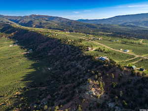 Aerial view of property's location with a mountain backdrop