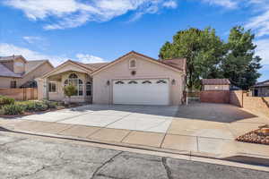 Mediterranean / spanish-style home featuring stucco siding, driveway, a tile roof, a garage, and a gate