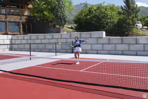 View of tennis court with a mountain view
