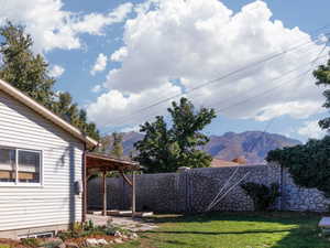 Fenced backyard featuring a patio area and a beautiful mountain view