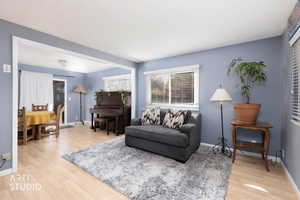 Living area featuring light wood-style floors and baseboards