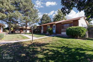Ranch-style house with brick siding and a front yard