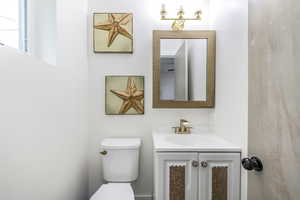 Bathroom featuring vanity and toilet