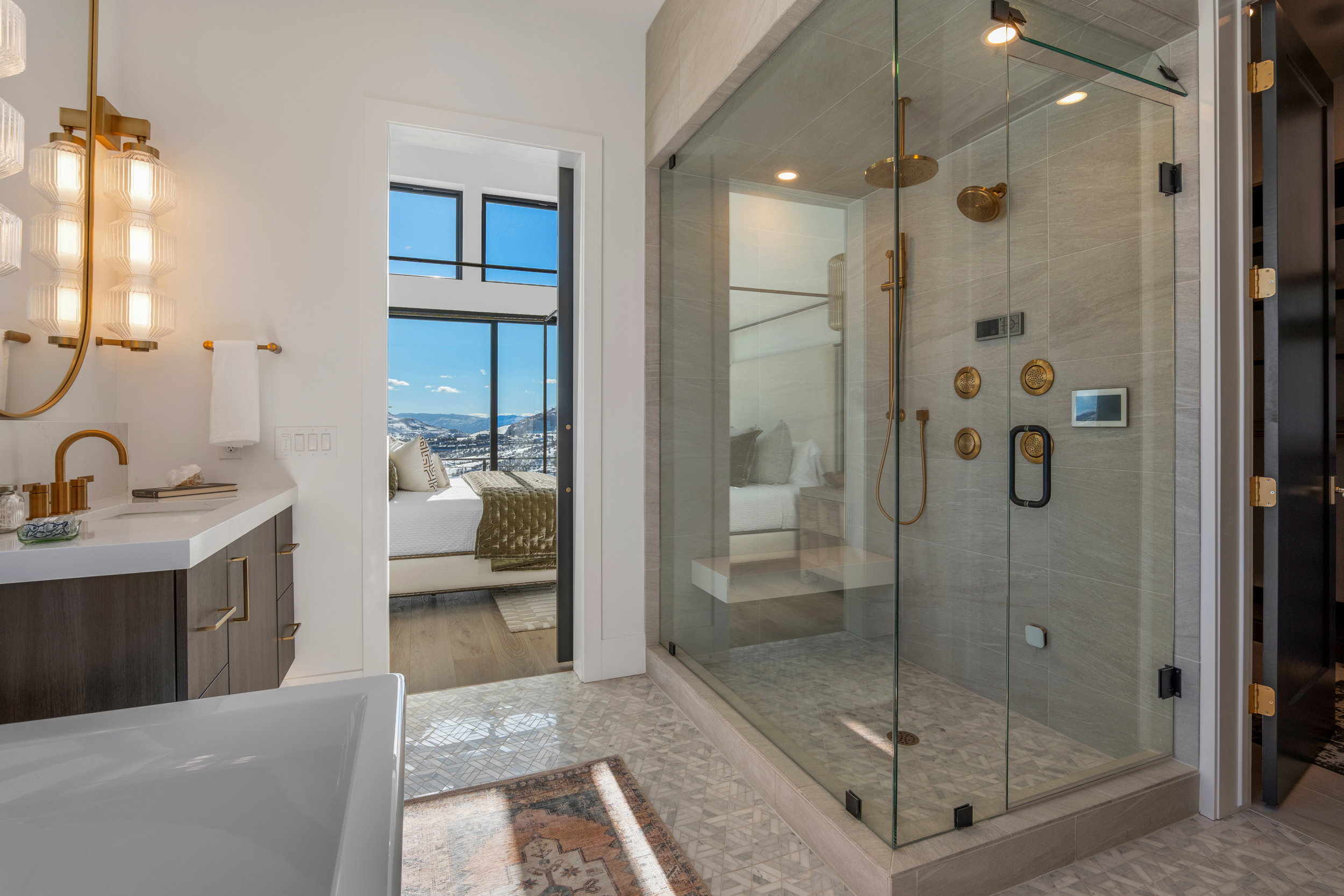 Ensuite bathroom featuring vanity, a stall shower, and a bathtub