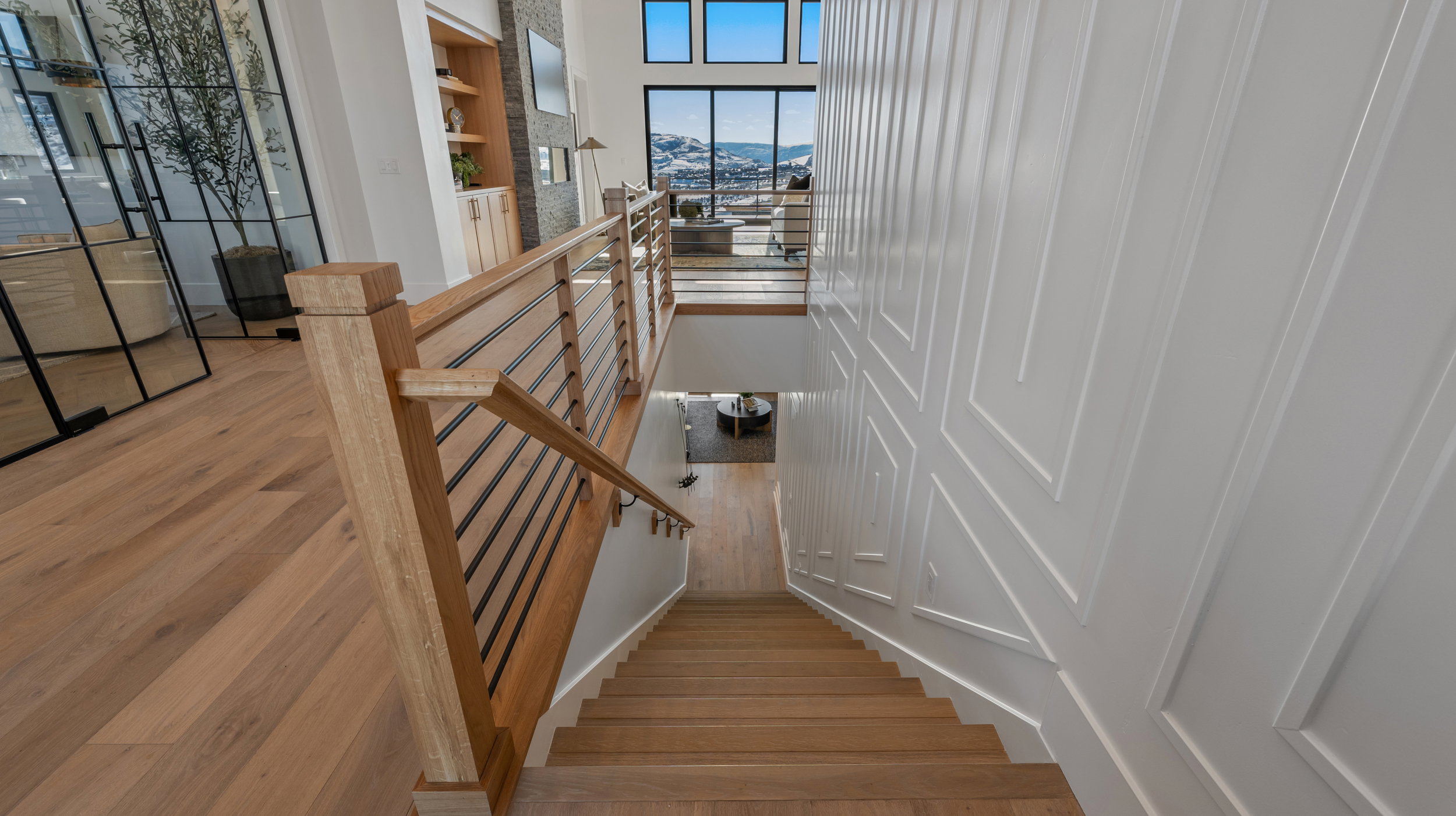 Stairway featuring wood finished floors and a mountain view