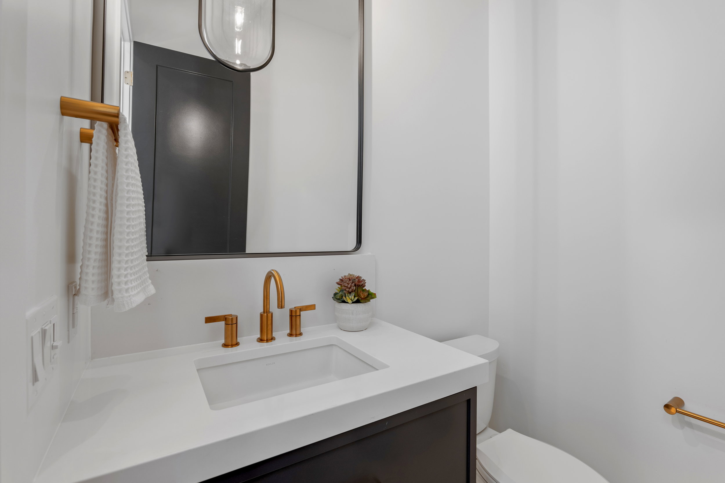 Half bathroom featuring vanity and toilet