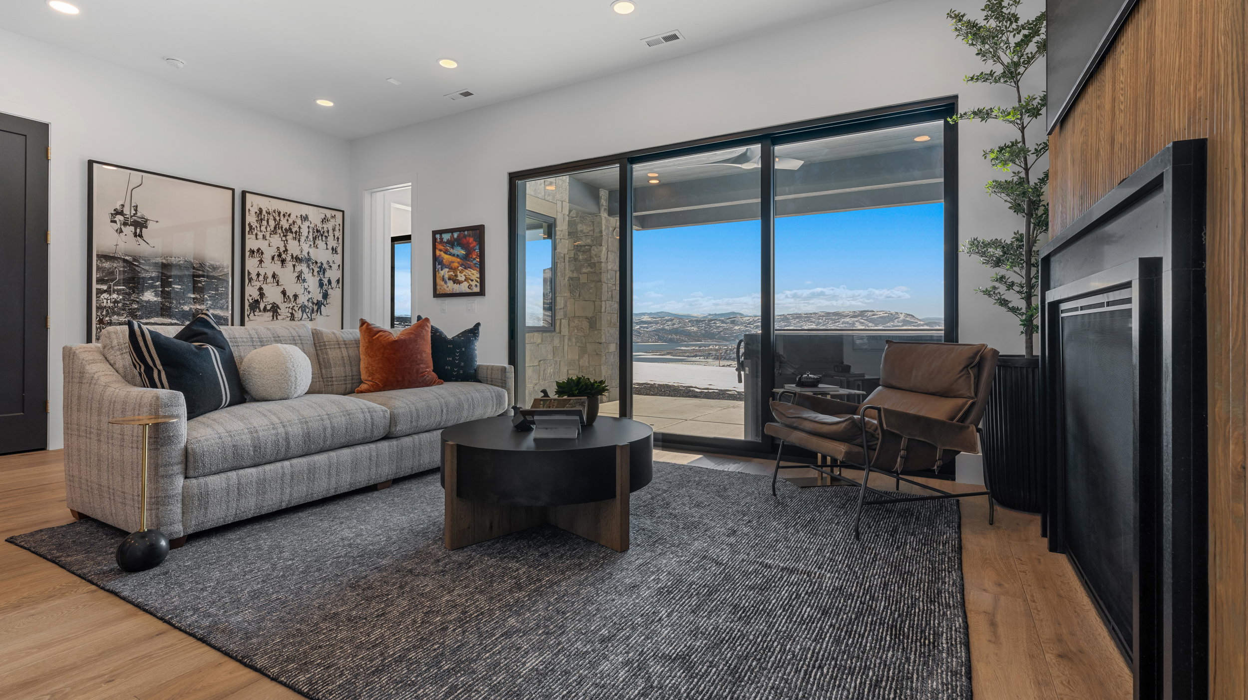 Living room featuring light wood-style flooring, recessed lighting, and a mountain view