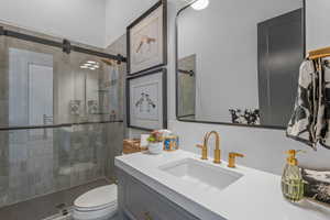 Full bathroom featuring vanity and a shower stall