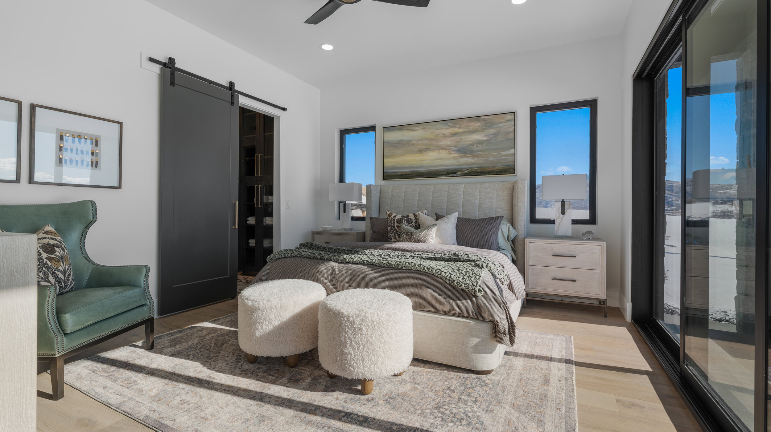 Bedroom featuring a barn door, light wood-type flooring, multiple windows, a ceiling fan, and recessed lighting