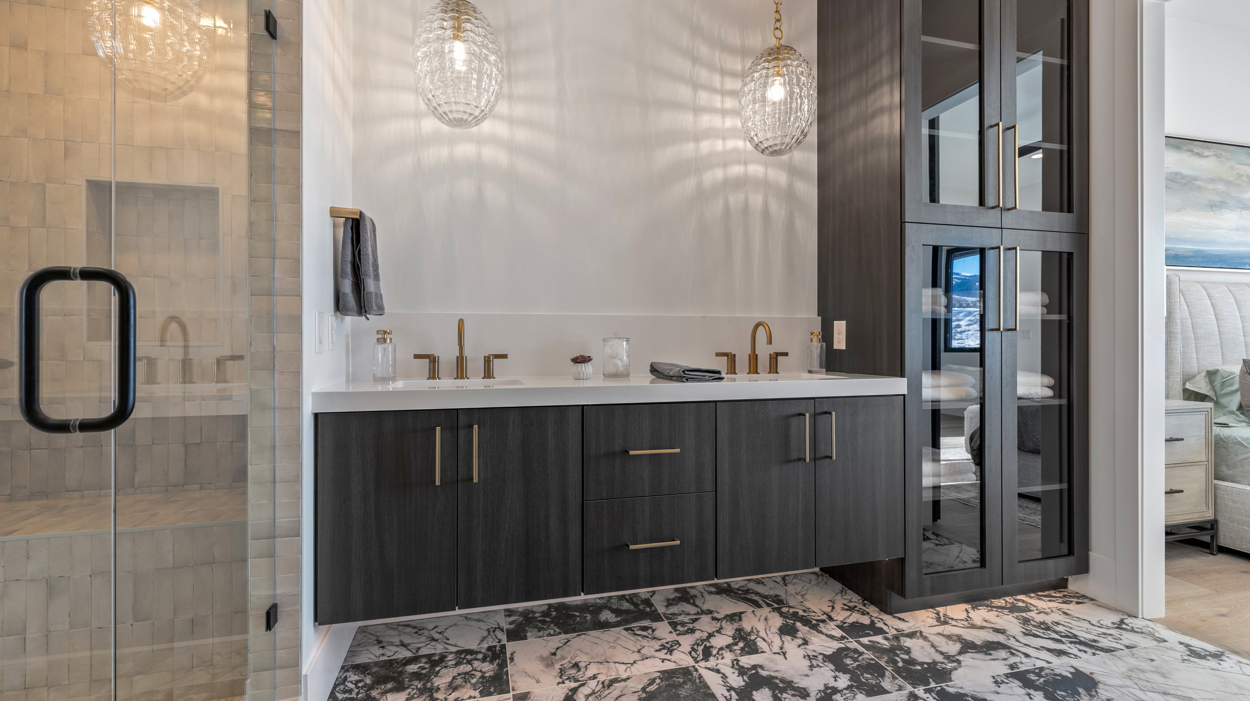 Bathroom featuring a stall shower and double vanity