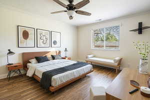 Bedroom featuring crown molding, wood finished floors, and a ceiling fan