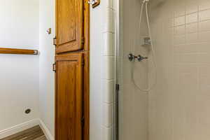 Full bathroom featuring a stall shower and wood finished floors