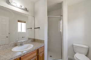 Full bath with vanity and a stall shower