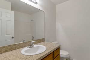 Bathroom featuring vanity and toilet