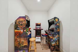 Recreation room with light wood-type flooring and baseboards