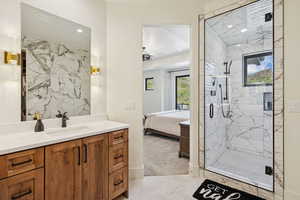 Full bathroom with vanity, a marble finish shower, connected bathroom, light tile patterned floors, and recessed lighting