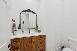 Half bathroom with vanity and toilet