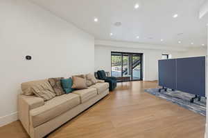 Living room featuring light wood-style flooring and recessed lighting