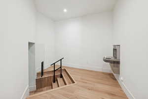 Interior space with light wood finished floors and recessed lighting