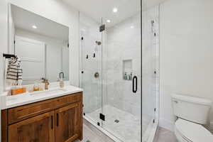 Full bath featuring a shower stall, vanity, recessed lighting, and light tile patterned flooring