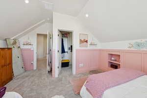 Bedroom featuring vaulted ceiling, light colored carpet, and recessed lighting