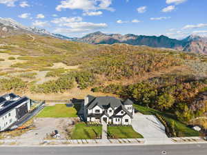 Aerial view of property and surrounding area with mountains