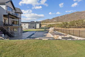 View of yard with stairway, a balcony, a patio area, and a mountain view