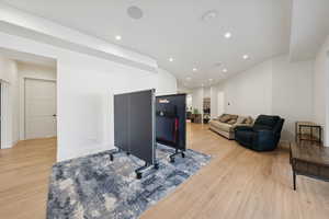 Living area with recessed lighting and light wood finished floors