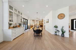 Dining area featuring recessed lighting, light wood-type flooring, and a chandelier