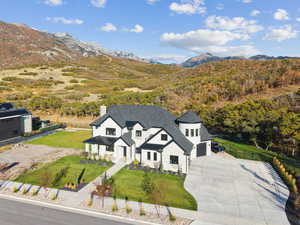 Aerial view of property and surrounding area with a mountainous background