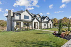 Modern inspired farmhouse featuring a standing seam roof, a metal roof, and a front yard