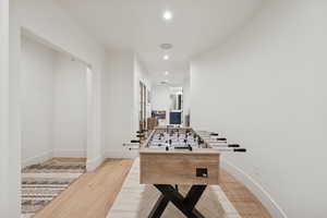 Recreation room featuring light wood-style flooring and recessed lighting