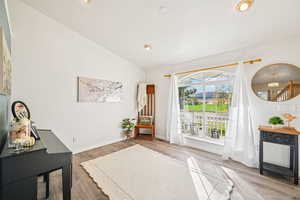 Living area featuring lofted ceiling and light wood-type flooring