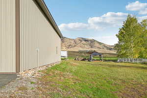 View of home's exterior with a gazebo, mountain, and rural views