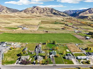 Aerial overview of property's location featuring a mountainous background and rural landscape