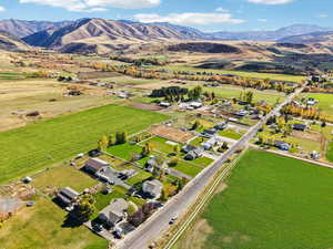Aerial view of property's location with a mountainous background and rural landscape