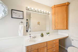 Half bath featuring vanity and toilet