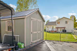 View of shed with a pergola on rear of home
