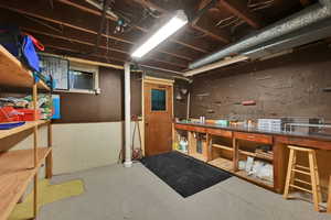Unfinished below grade area featuring a workshop area