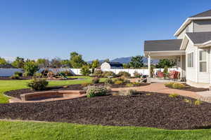 Fenced backyard featuring a playground and a mountain view