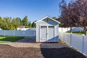 View of shed with a fenced backyard