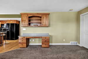 Unfurnished office with baseboards and light carpet